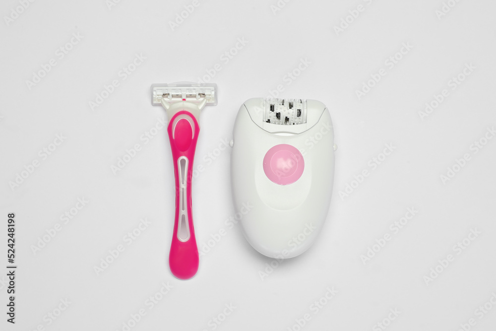 Modern epilator and razor on white background, flat lay Modern epilator and razor on white background, flat lay