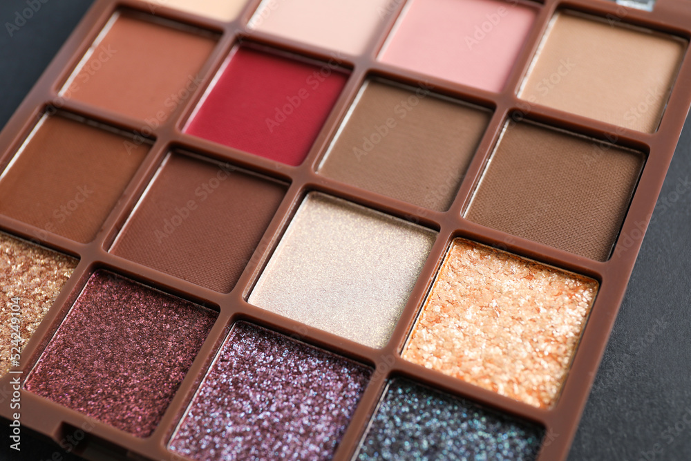 Colorful eyeshadow palette on dark background, closeup Colorful eyeshadow palette on dark background, closeup