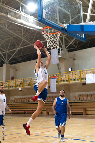 Basketball players playing basketball in the sports hall