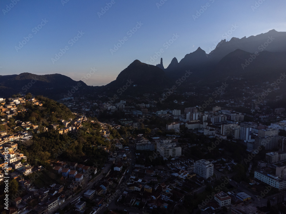 Aerial view of the city of Teresópolis. Mountains and hills with blue sky and many houses in the mountain region of Rio de Janeiro, Brazil. Drone photo. Araras, Teresópolis. Sunny day. Sunset