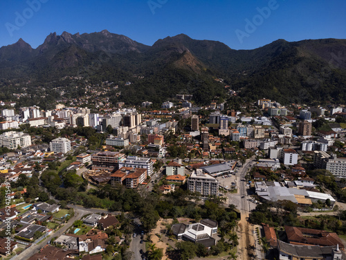 Aerial view of the city of Teresópolis. Mountains and hills with blue sky and many houses in the mountain region of Rio de Janeiro, Brazil. Drone photo. Araras, Teresópolis. Sunny day. Sunrise © Diego