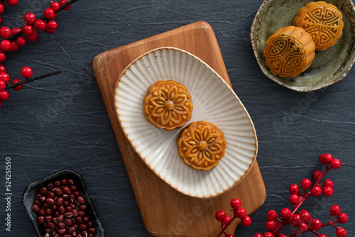 Delicious Cantonese moon cake for Mid-Autumn Festival food mooncake on blue table background.