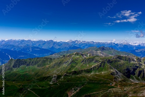 Scenic shot of green covered hills under the peaceful blue sky photo