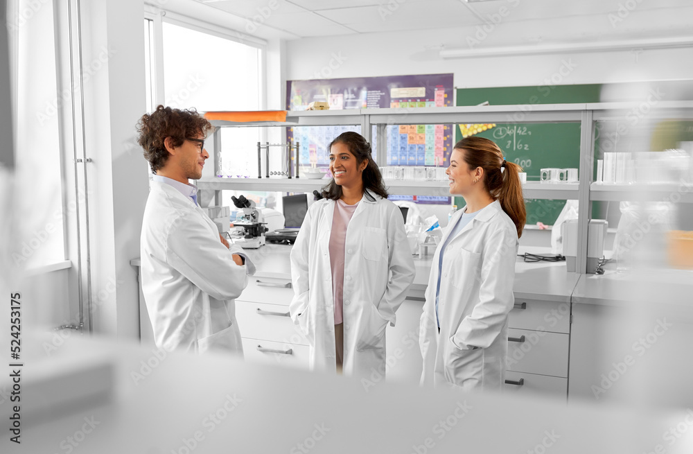 science, work and people concept - international group of happy scientists talking in laboratory science, work and people concept - international group of happy scientists talking in laboratory