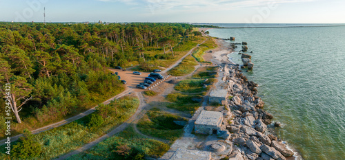 Fototapeta Naklejka Na Ścianę i Meble -  Ruins of bunkers on the beach of the Baltic sea, part of an old fort in the former Soviet base Karosta in Liepaja, Latvia. Sunset landscape.