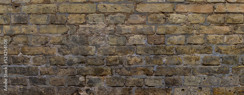 Wide weathered beige brown brick wall background