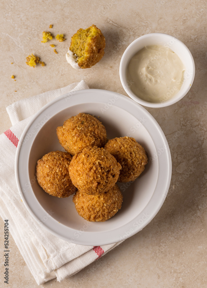 Falafel - popular middle eastern street food with garlic sauce. Top view. Scrumptious vegetarian dish from Middle east called Falafil shot from above angle. Falafel - popular middle eastern street food with garlic sauce. Top view. Scrumptious vegetarian dish from Middle east called Falafil shot from above angle.