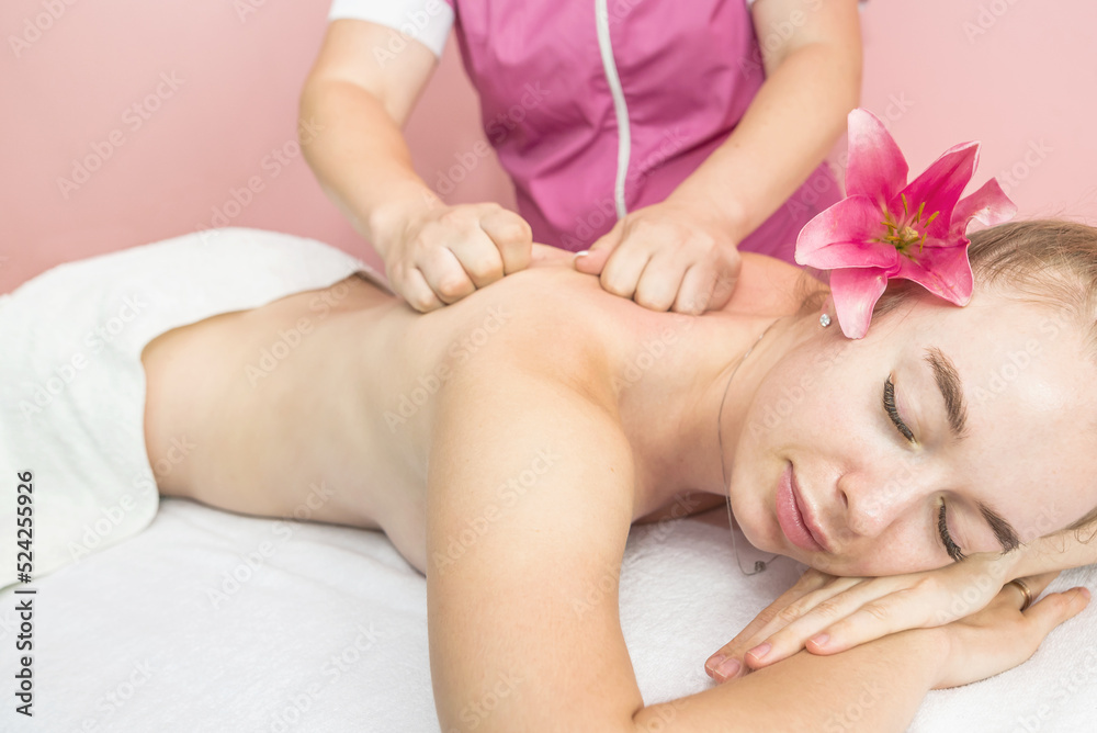 Young beautiful woman getting relaxing back and body massage Young beautiful woman getting relaxing back and body massage
