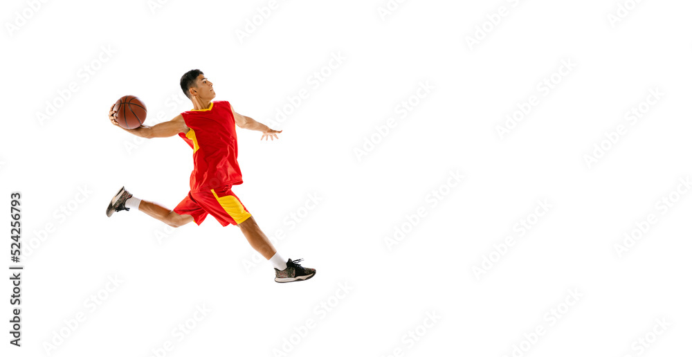 Portrait of young man, basketball player throwing ball into basket in a run isolated over white studio background. Flyer