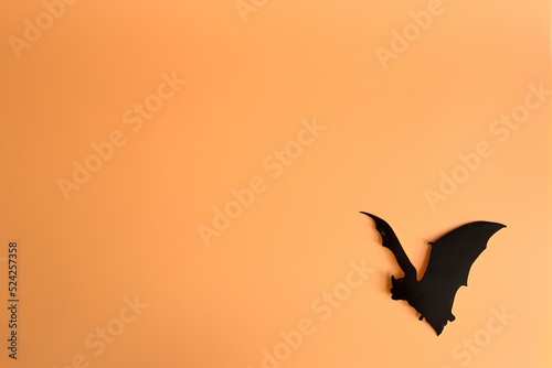 Silhouette of bat on a orange background. Creative halloween concept backdrop. halloween bat craft.