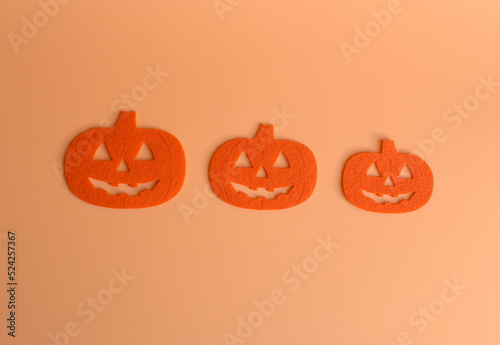 Three Beautiful pumpkin on a orange background. Creative halloween concept backdrop. halloween pumpkin craft.