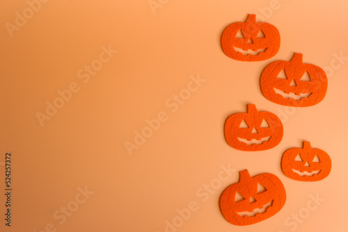 Five Beautiful pumpkin on a orange background. Creative halloween concept backdrop. halloween pumpkin craft.	