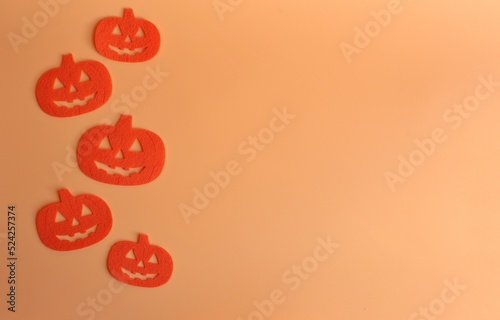Five Beautiful pumpkin on a orange background. Creative halloween concept backdrop. halloween pumpkin craft.
