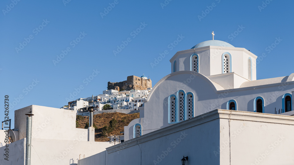 Agios Nikolaos church on Astypalea Island with Guerini Castle in the background.