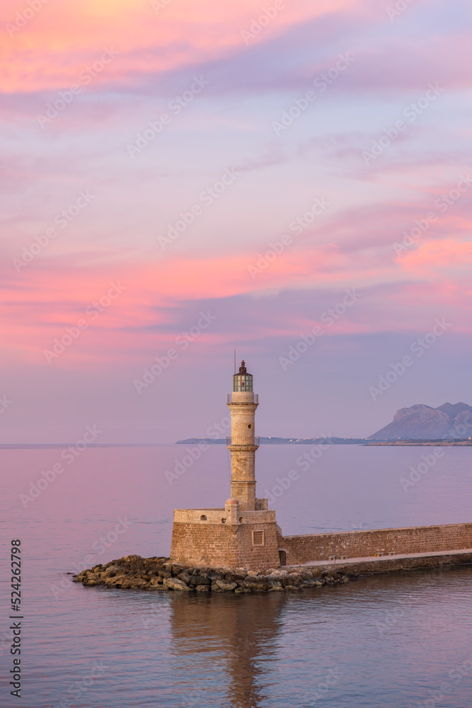 Pink sunset over the Venetian lighthouse in Chania on the island of Crete in Greece.