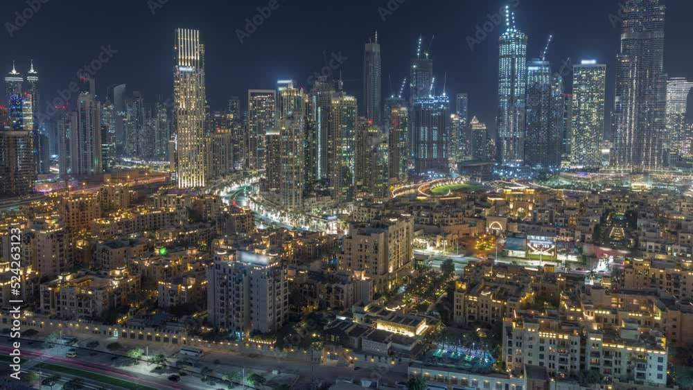 Close up view to Dubai's business bay towers aerial day to night transition timelapse. Rooftop view of some skyscrapers and new towers under construction after sunset Close up view to Dubai's business bay towers aerial day to night transition timelapse. Rooftop view of some skyscrapers and new towers under construction after sunset