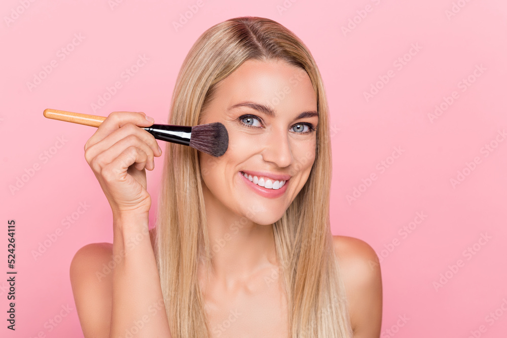 Photo of joyful lady prepare dinner husband use rouge brush cheeks isolated over pink color background Photo of joyful lady prepare dinner husband use rouge brush cheeks isolated over pink color background
