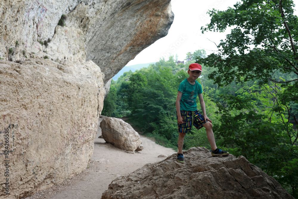Boy posing in grotto of Belaya river valley