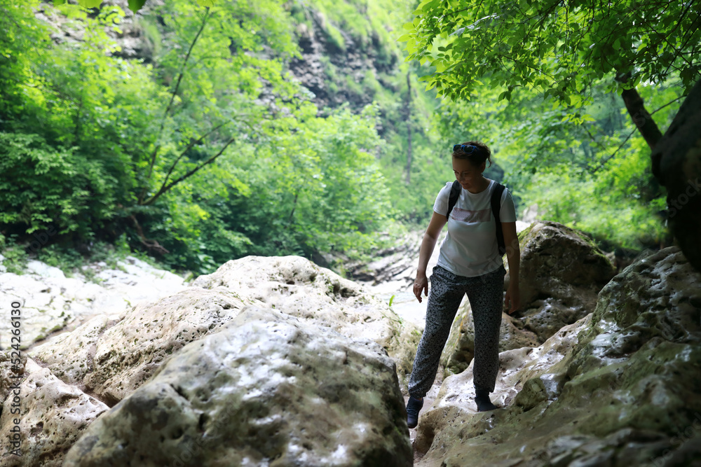 Portrait of woman walking along canyon path to Rufabgo Waterfalls Portrait of woman walking along canyon path to Rufabgo Waterfalls