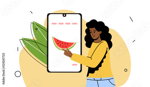 the girl chooses products online. Farm fruits in the app, food delivery to the house. Contactless purchase. The girl next to the phone.