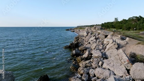 Ruins of bunkers on the beach of the Baltic sea, part of an old fort in the former Soviet base Karosta in Liepaja, Latvia. Sunset landscape. photo