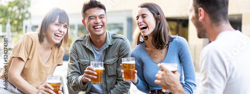 Horizontal banner or header with happy multiracial friends group drinking beer at brewery pub restaurant - Friendship concept with young people having fun and laughing together - Focus on asian man