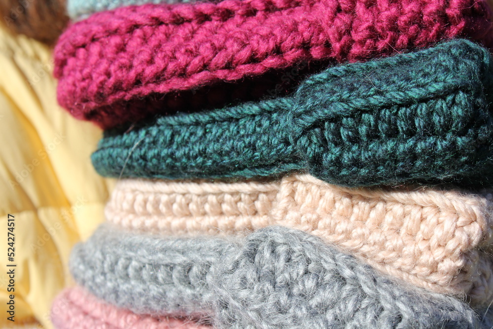 A lot of fashionable knitted hats in the hands of an unrecognizable young girl close-up. Fashion autumn-winter. Knitted voluminous hats. Autumn shooting. City Style. Knitting. Hobby. Handmade. A lot of fashionable knitted hats in the hands of an unrecognizable young girl close-up. Fashion autumn-winter. Knitted voluminous hats. Autumn shooting. City Style. Knitting. Hobby. Handmade.