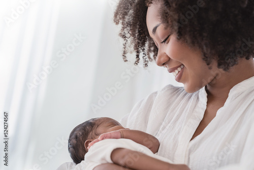 Close up portrait of beautiful young African American  mother holding sleep newborn baby in hospital. Healthcare medical love black afro woman lifestyle mother\'s day, breast concept with copy space.