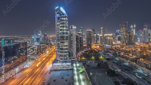Wallpaper Mural Dubai's business bay towers panorama aerial night timelapse. Rooftop view of some skyscrapers and new towers under construction with parking and traffic on the street Torontodigital.ca