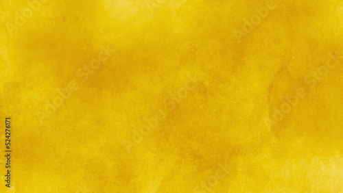 Yellow wall of a renovated italian farmhouse, textured background with brushstrokes. Abstract orange background