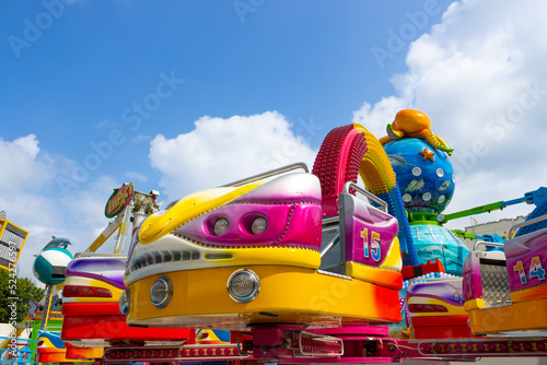 A gondola belonging to an octopus ride on an arm full of lights on the funfair in Oss city (North Brabant, the Netherlands). The attraction has bright colors and has an ocean theme. photo