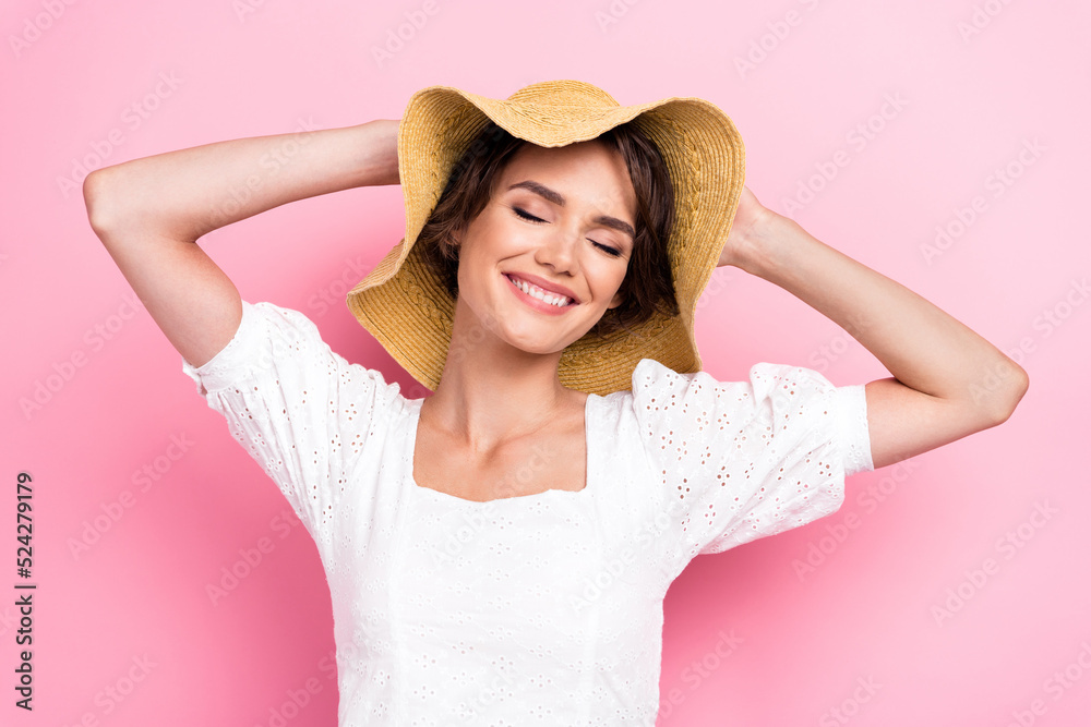 Photo of adorable shiny lady wear white blouse arms straw cap closed eyes isolated pink color background Photo of adorable shiny lady wear white blouse arms straw cap closed eyes isolated pink color background