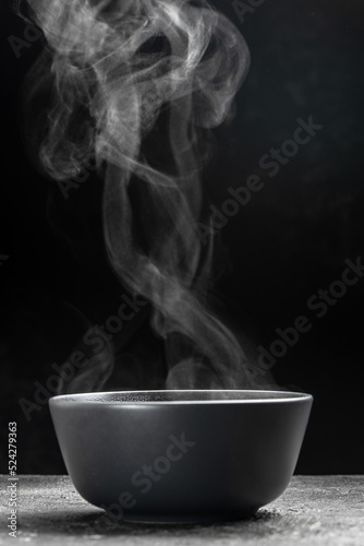 steam over cooking pot on black background, Hot food. Bowl of hot steam with smoke, Culinary, cooking, concept