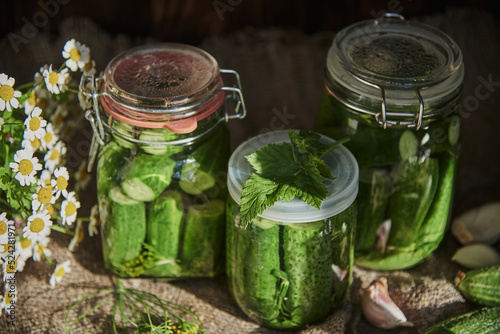  Salted, pickled cucumbers in a jar on an old wooden table