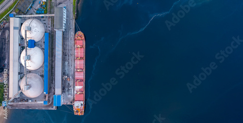 Lng Tanker ship for transportation of liquefied gas stands in port for loading, Aerial top view photo
