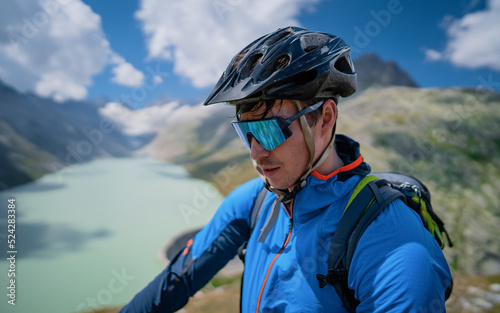 Portrait of a man. A mountainbiker search the trail with his GPS computer