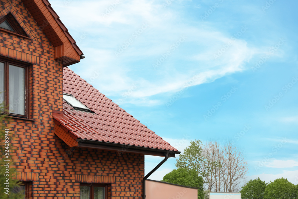 Beautiful house with red roof against blue sky Beautiful house with red roof against blue sky