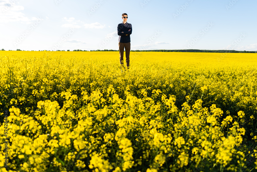 Man in the field. Agriculture - country outdoor scenery, warm sunset light.