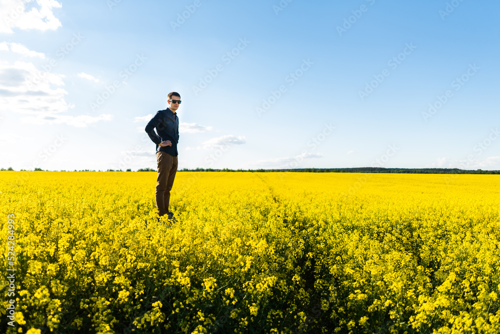 Man in the field. Agriculture - country outdoor scenery, warm sunset light.