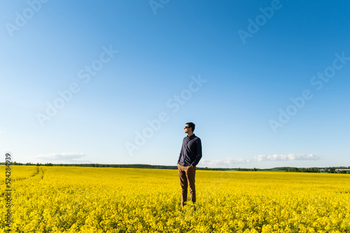 Man in the field. Agriculture - country outdoor scenery, warm sunset light. © Pavel