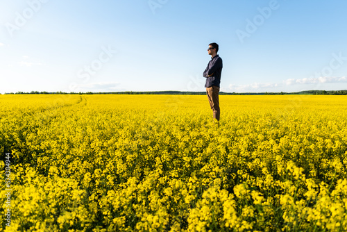 Man in the field. Agriculture - country outdoor scenery, warm sunset light.