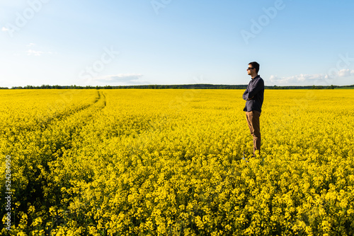 Man in the field. Agriculture - country outdoor scenery  warm sunset light.