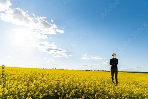 Man in the field. Agriculture - country outdoor scenery, warm sunset light.