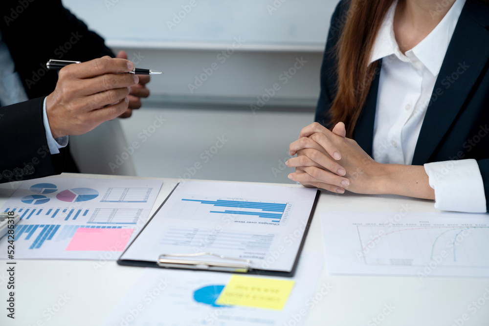 businessman holding a pen and hands to explain the details to the participant businessman holding a pen and hands to explain the details to the participant