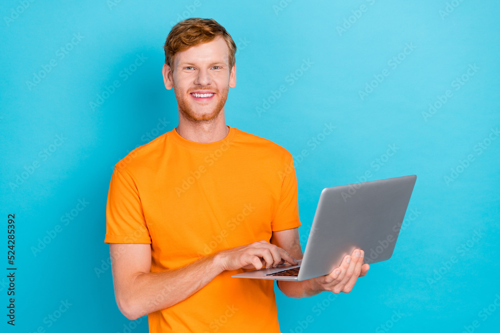 Photo of satisfied man boy arm hold netbook touch keyboard enjoy new quality purchase empty space isolated on cyan color background Photo of satisfied man boy arm hold netbook touch keyboard enjoy new quality purchase empty space isolated on cyan color background