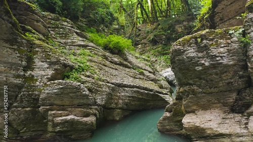 Wet canyon of the Psakho river. Mountain river with blue water. Sochi, Russia. Natural background