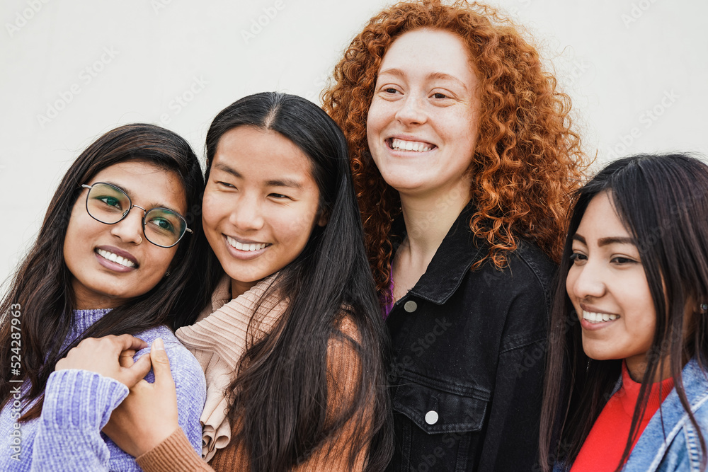 Happy diverse young women hugging each other outdoor - Multiethnic female friends Happy diverse young women hugging each other outdoor - Multiethnic female friends