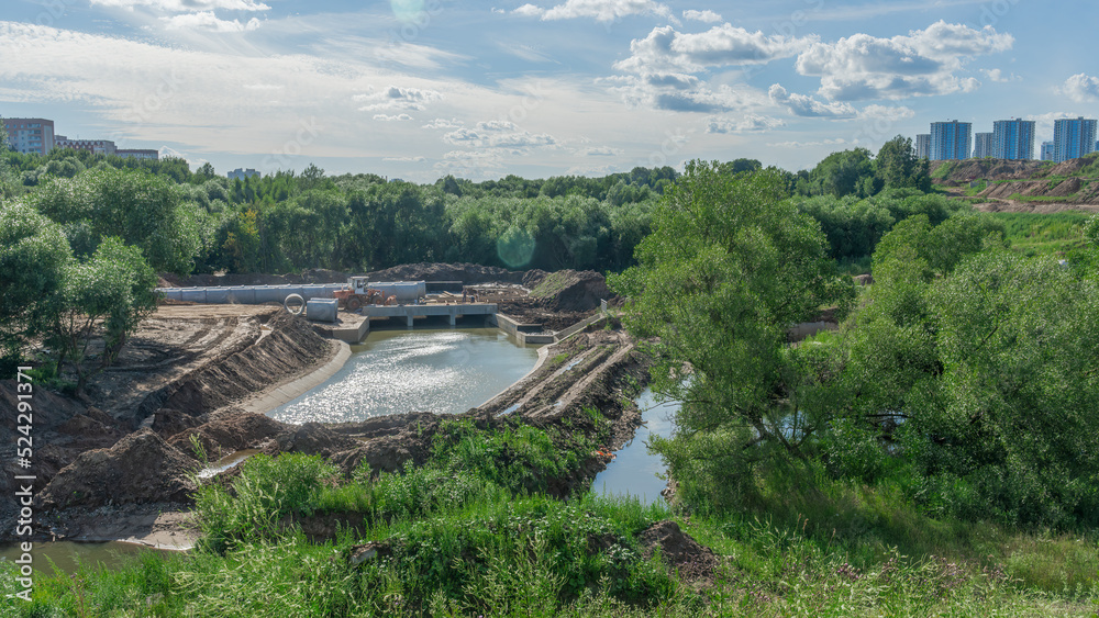 Construction of the river drains. Construction drains to prevent flooding in the city. Drain water into the river.