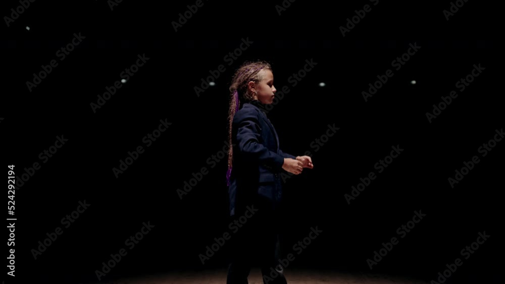portrait of little stylish girl on scene, dancing like robot or doll, contemporary dance performance portrait of little stylish girl on scene, dancing like robot or doll, contemporary dance performance