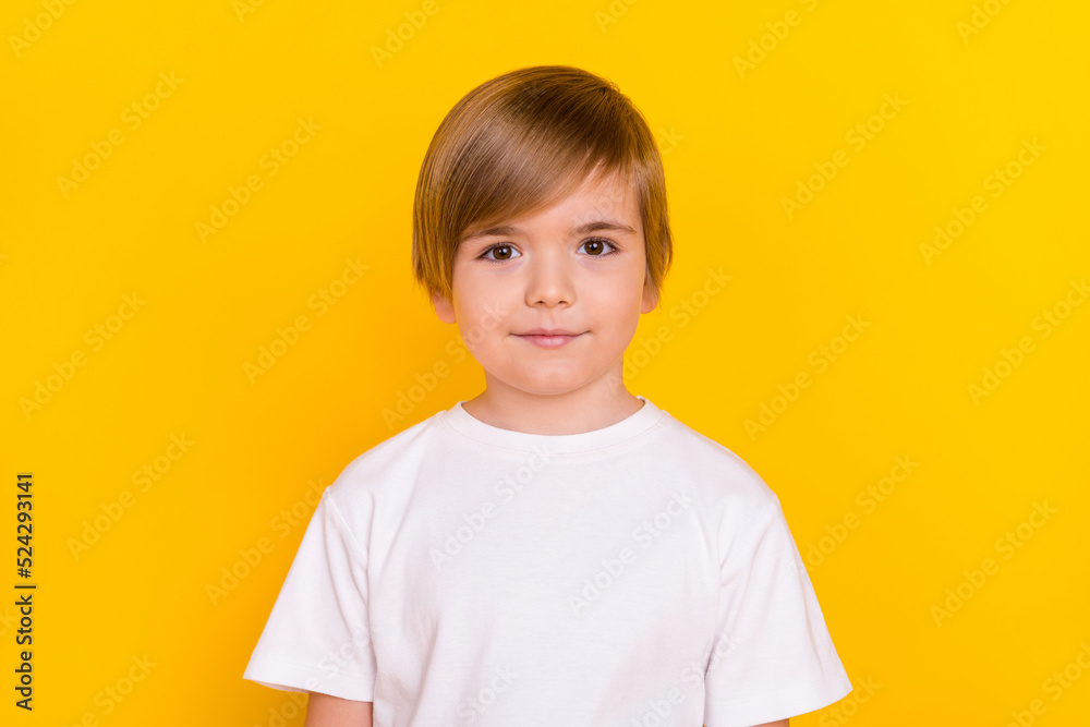 Portrait of attractive cheery pre-teen boy nerd wearing white t-shirt isolated over vibrant yellow color background Portrait of attractive cheery pre-teen boy nerd wearing white t-shirt isolated over vibrant yellow color background